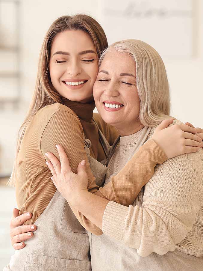 Young woman and mother spending time together at home Teeth Cleaning in Kernersville, NC